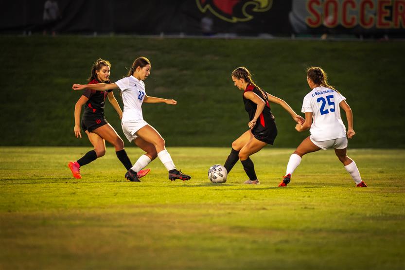 soccer players dribble the ball